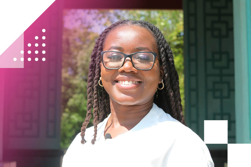 Smiling young black woman in sun