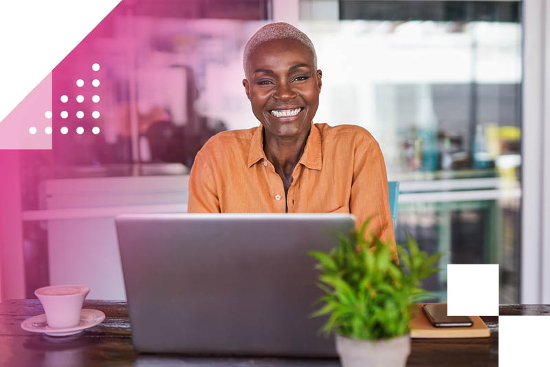 Smiling black woman working at a laptop