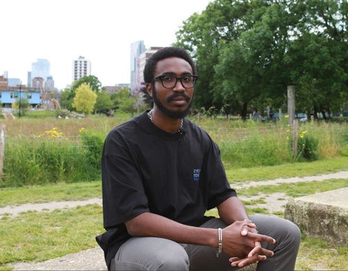 Image of Carlos sitting down in Shoreditch Park